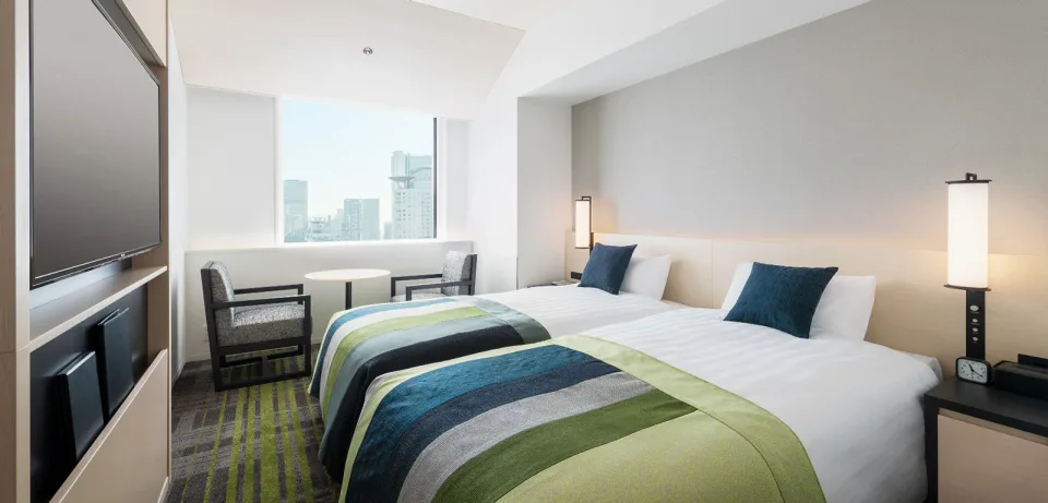 ห้องพักและพื้นที่เตียงของ The Park Front Hotel