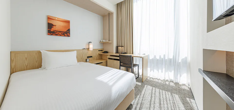 ห้องพักและพื้นที่เตียงของ JR Kyushu Hotel Blossom Shinjuku